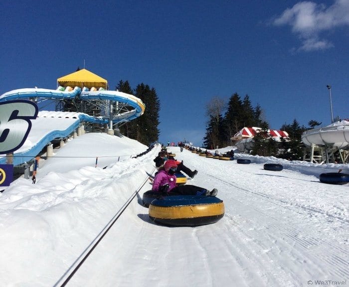 snow tubes being pulled up the hill