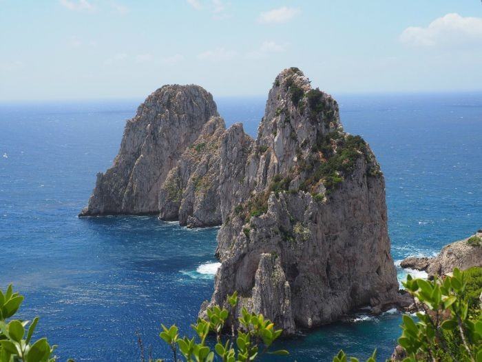 A hike to the Natural Arch in Capri Italy includes views of the arch, the Faraglioni rocks and a stop at the Grotto di Matermania.