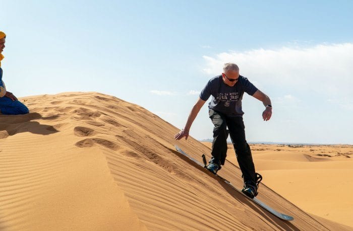 Glenn sand boarding on the dunes