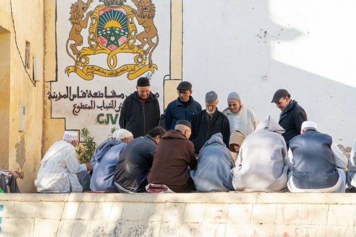 Men playing cards in the medina of Fes