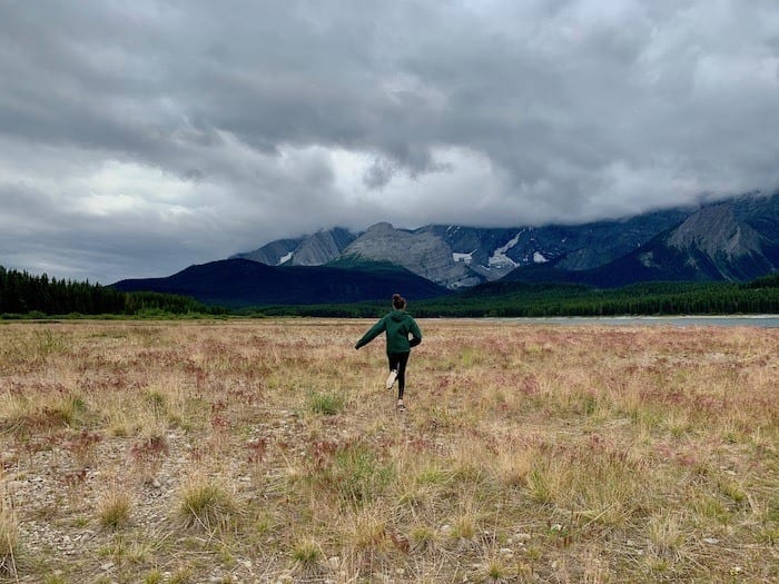 Running through the meadow at Lower Kananaskis Lake