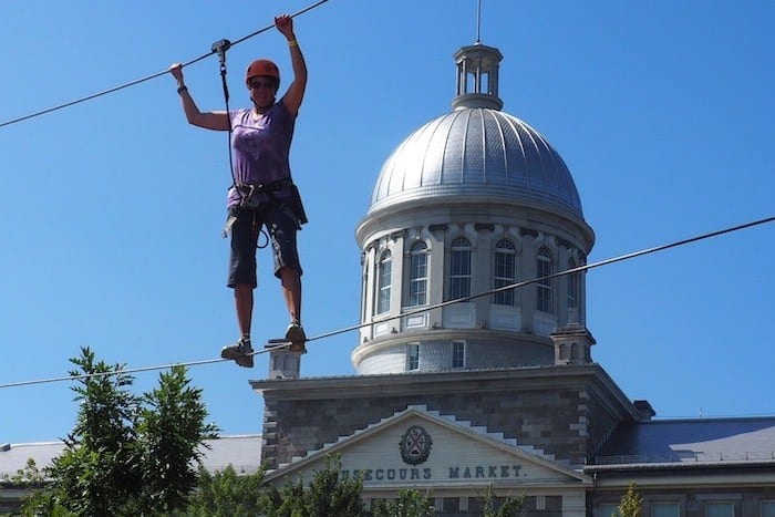 Woman on tight rope on Voiles en Voiles adventure course in Montreal