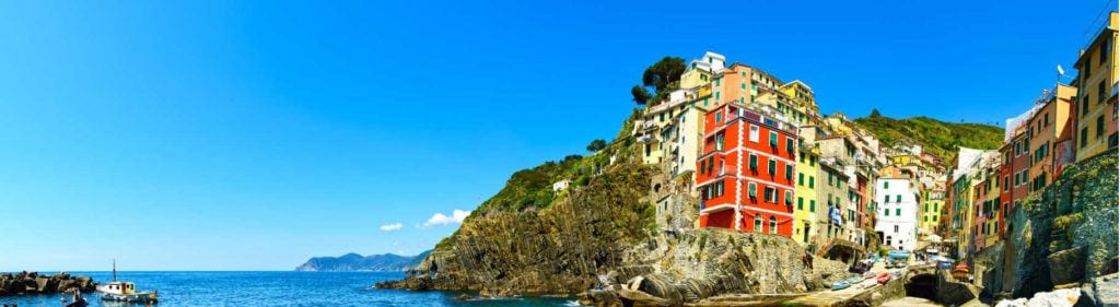 Riomaggiore village panoramic view on cliff rocks, boats and sea., Seascape in Five lands, Cinque Terre National Park, Liguria Italy Europe.