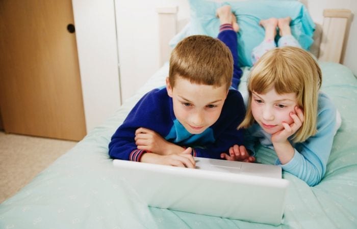 kids planning family vacation on computer
