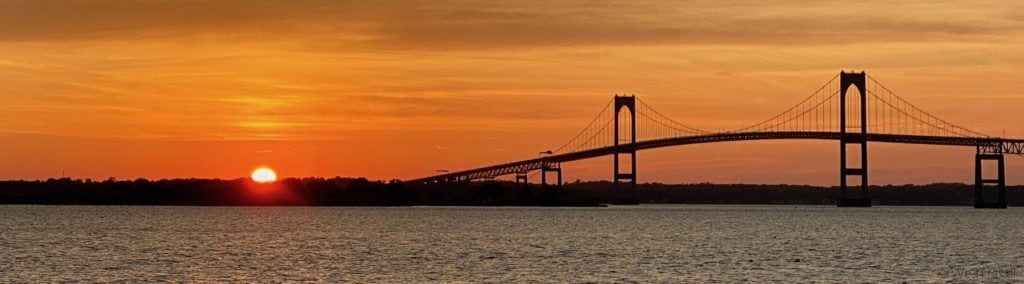 sunsetting behind Newport Pell Bridge
