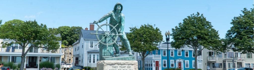 Fishermen's memorial and houses in downtown Gloucester MA