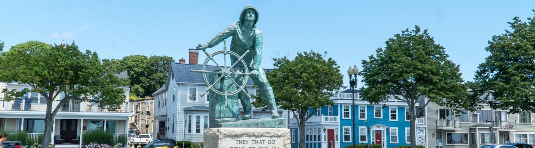 Fishermen's memorial and houses in downtown Gloucester MA