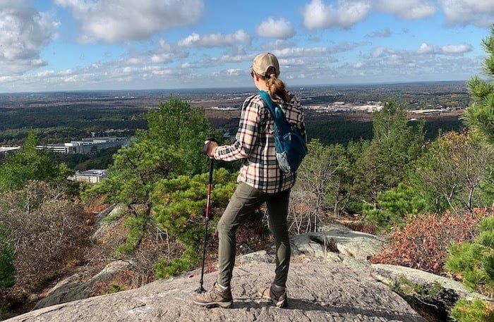 Woman hiker from behind overlooking Blue Hills Reservation