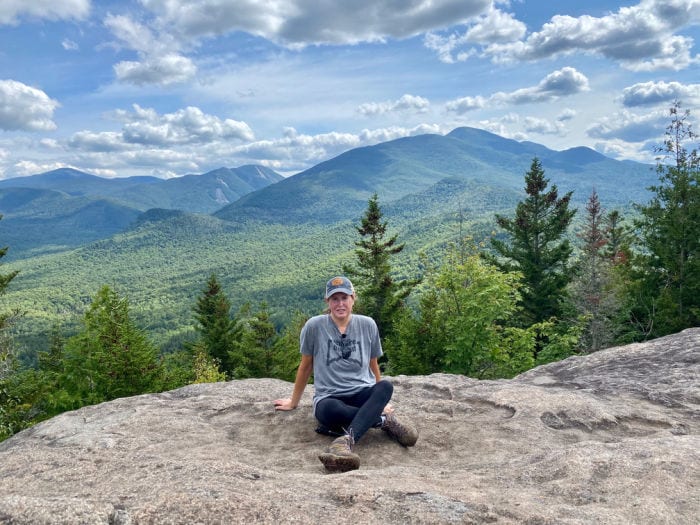 women hiker sitting on summit at Mt Jo near Lake Placid