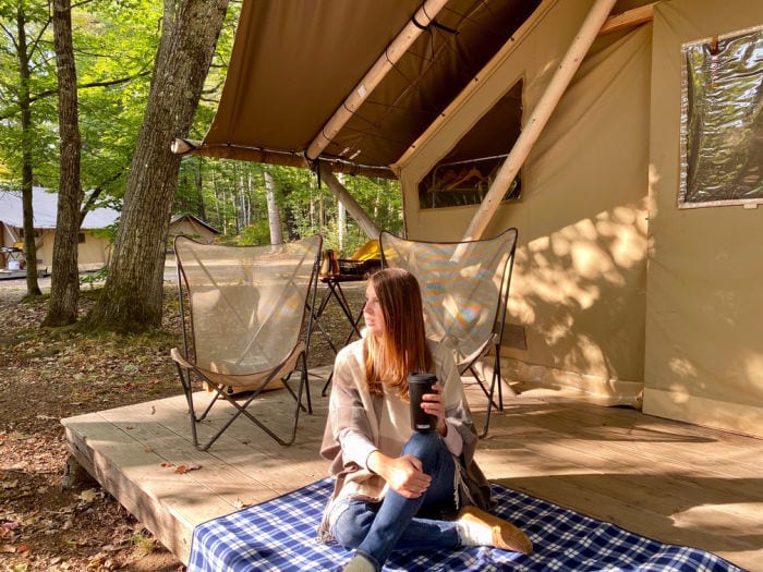 Drinking from CamelBak MultiBev on porch of glamping tent 