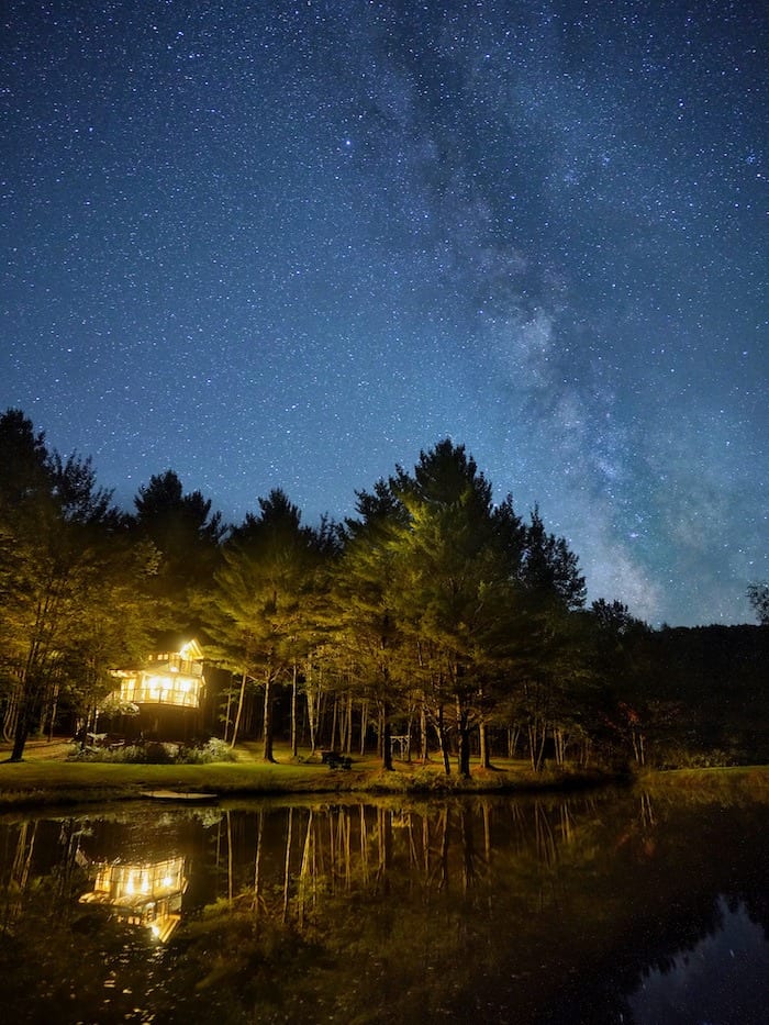 Moose Meadow Lodge treehouse at night with the Milky Way above