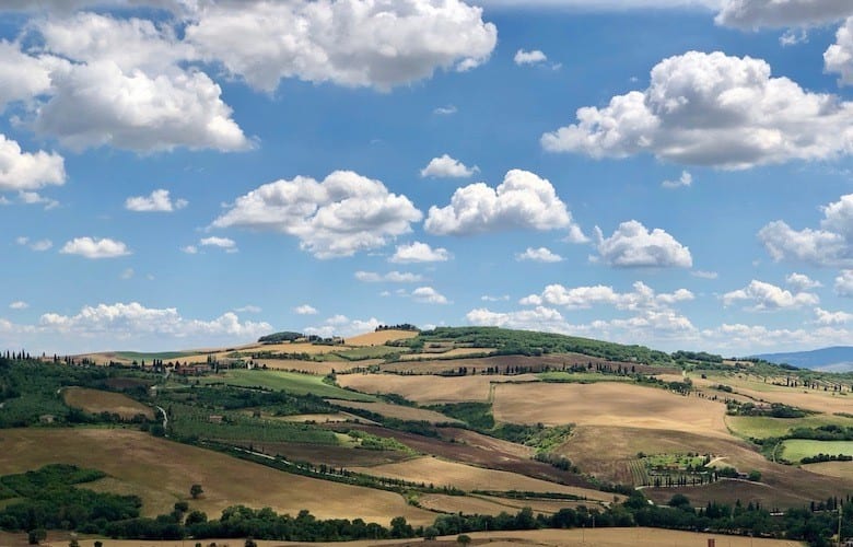 Tuscan hillside outside of Pienza with blue sky and clouds