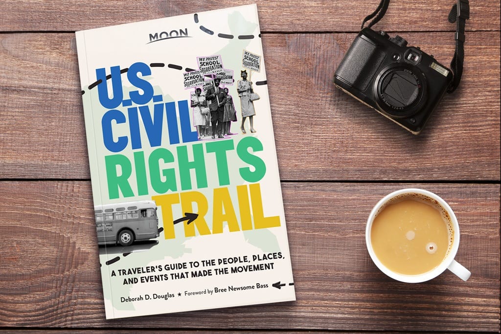 Moon Guide U.S. Civil Rights Trail guidebook with camera and coffee cup