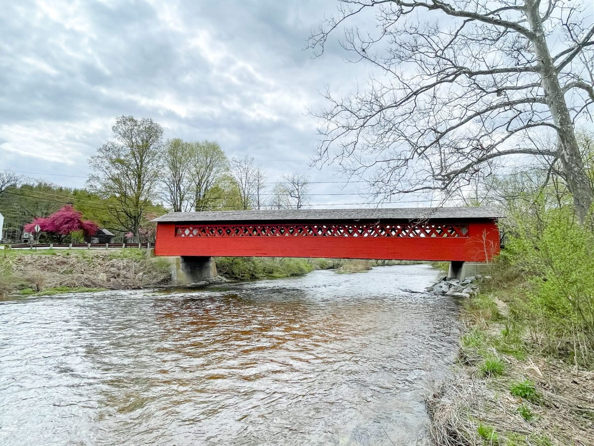 Red covered bridge over a river