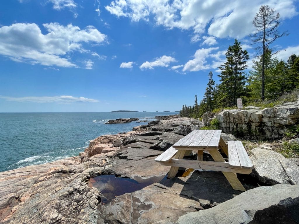 picnic table on rocks overlooking water at McClellan Park in Milbridge ME