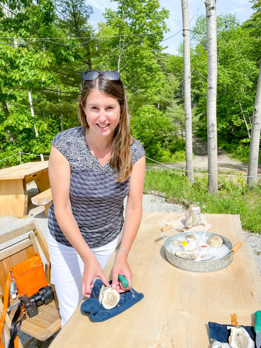 Woman shucking oysters at Glidden Point Oyster Farm