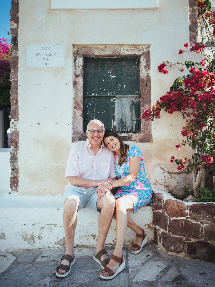 Couple sitting with woman leaning her head on the man's shoulder