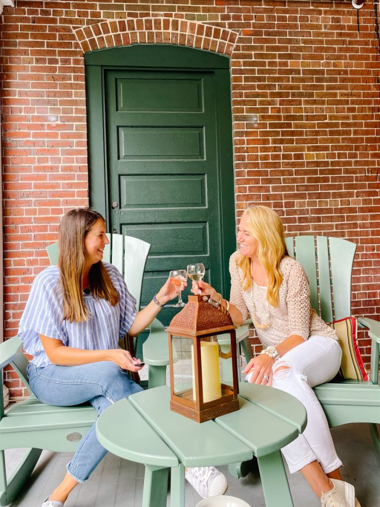 two women with wine glasses on porch at Inn at Diamond Cove