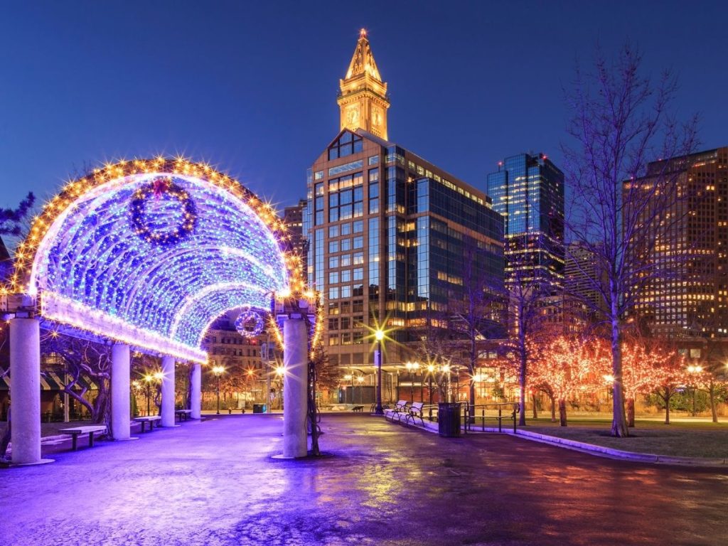 Lighted walkway and buildings decorated for Christmas at night in Boston