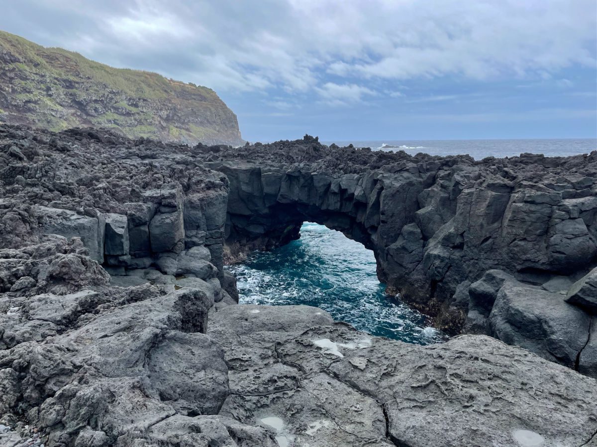 Stone arch over water in Ferraria Sao Miguel in the Azores