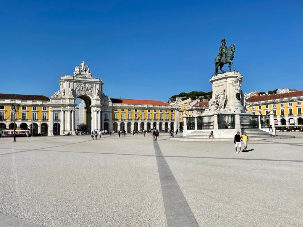 Commerce Square in Lisbon with yellow buildings and arch