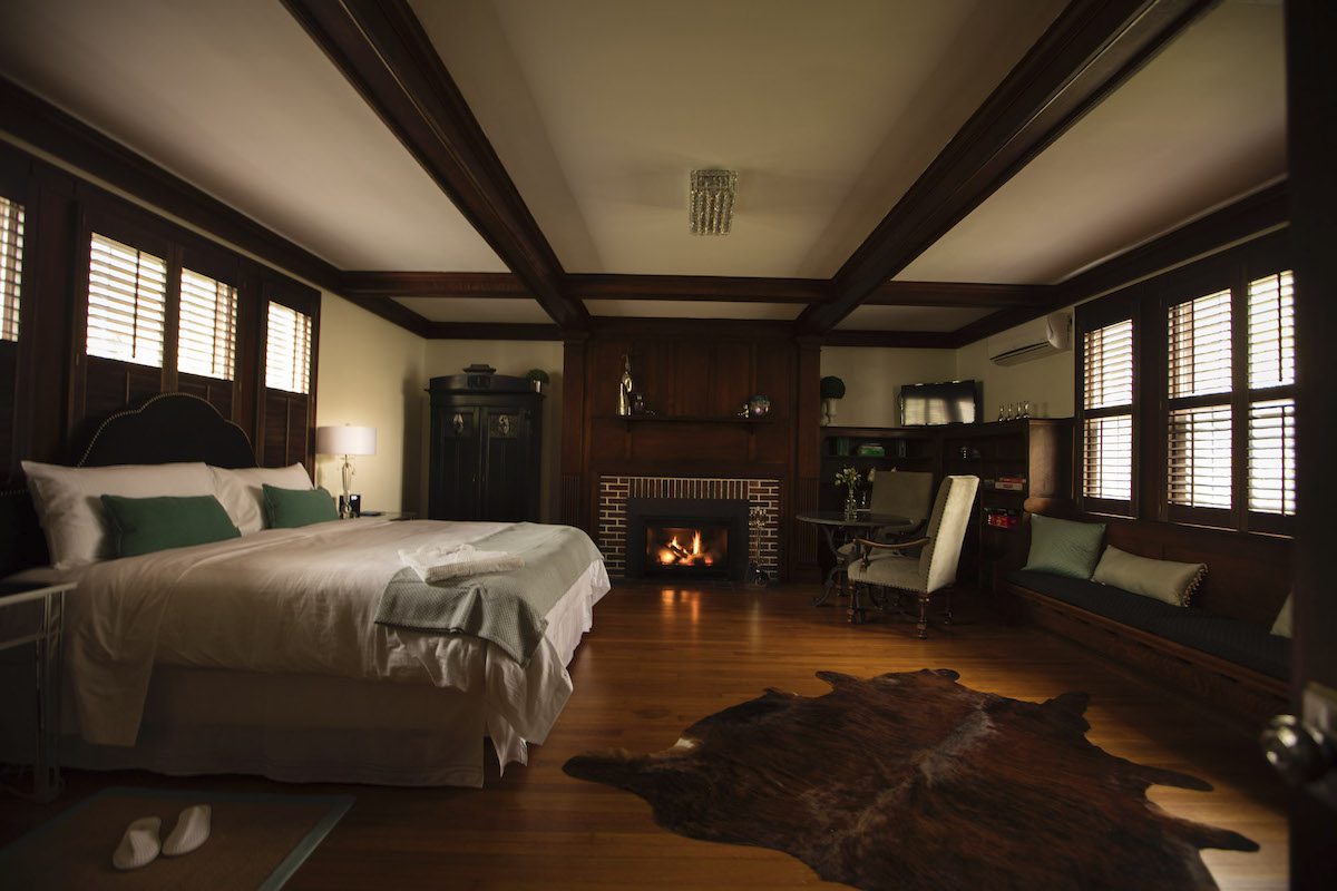 library with bed and fireplace at the Nobnocket Boutique Inn