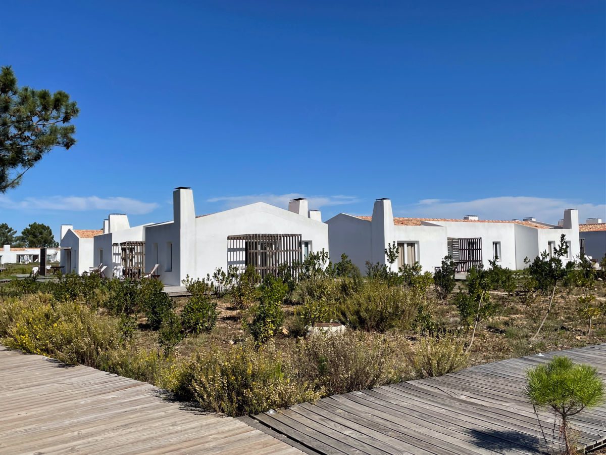 White villas with scrub brush in front at Craveiral Farmhouse