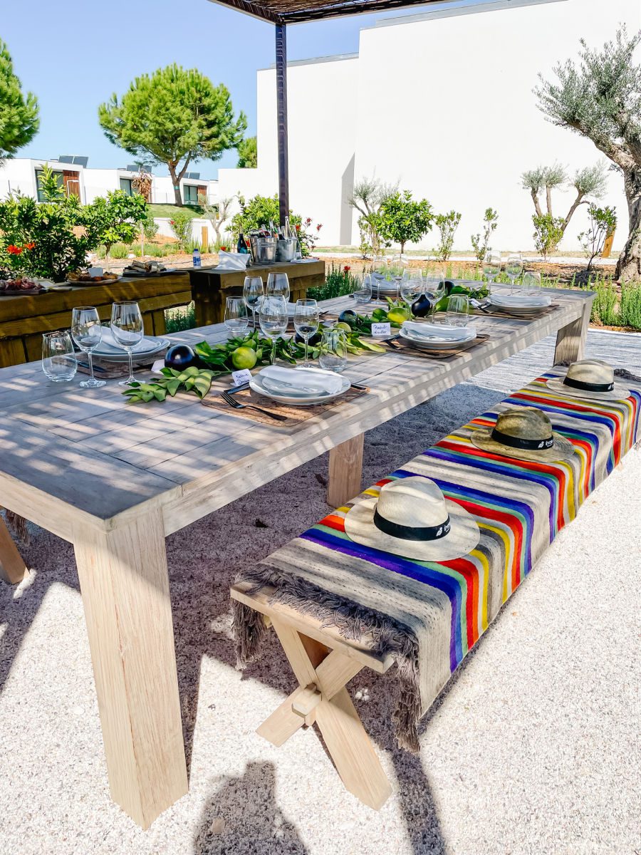 Evora Farm Hotel Picnic table set with a colorful blanket and plates and glasses