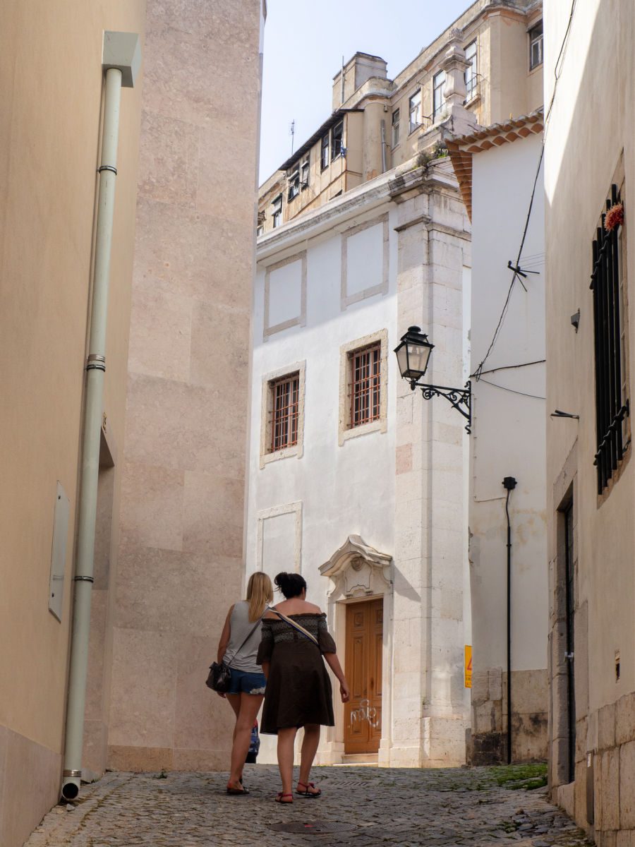 Two women walking on the street in the Alfama district