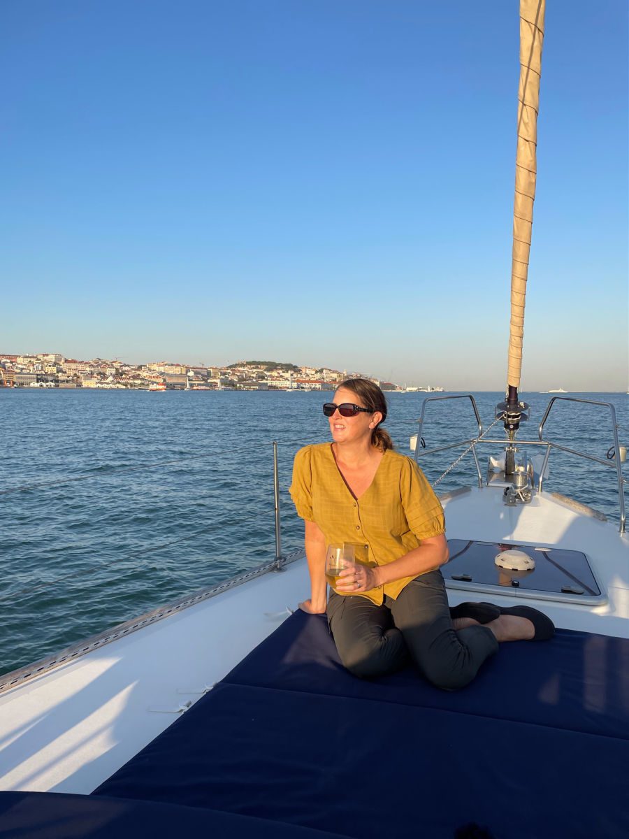 Woman on sailboat on the Tagus River with Lisbon in the background