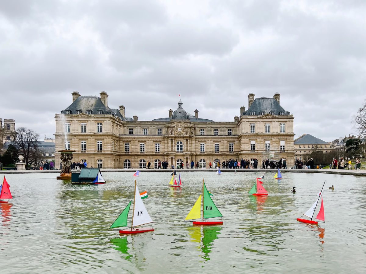 Luxembourg Palace with toy sailboats in the pond in front