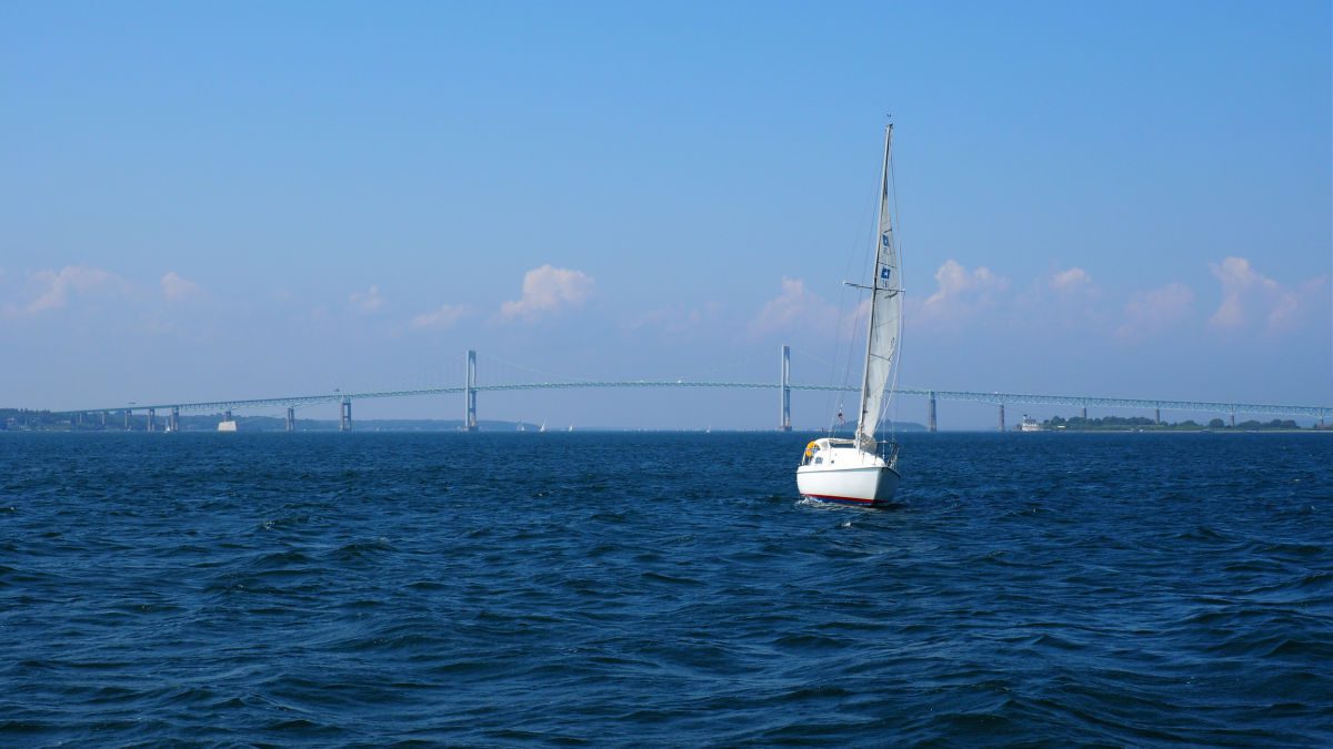 Sailboat on harbor with Pell Bridge in the background