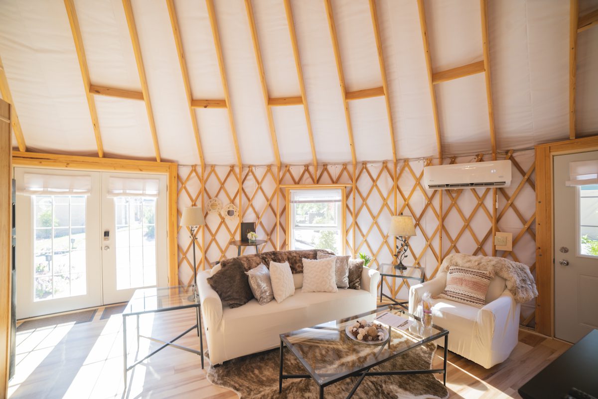 Living room area inside yurt at Acadia Wilderness Lodge