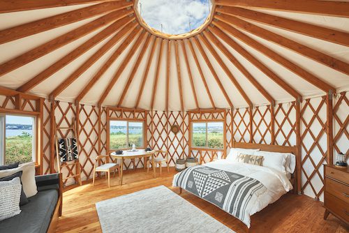 Living room area inside yurt at Acadia Wilderness Lodge