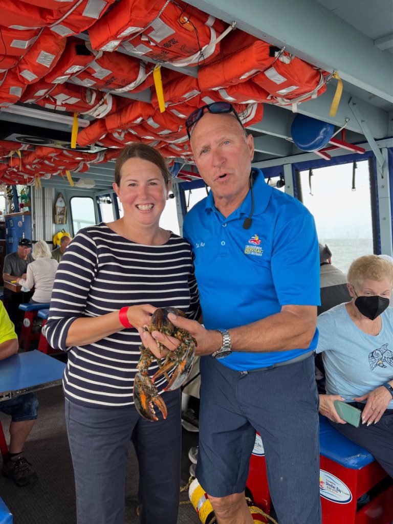 Tamara and Captain Ron holding lobster on  the Lobster Tales boat cruise