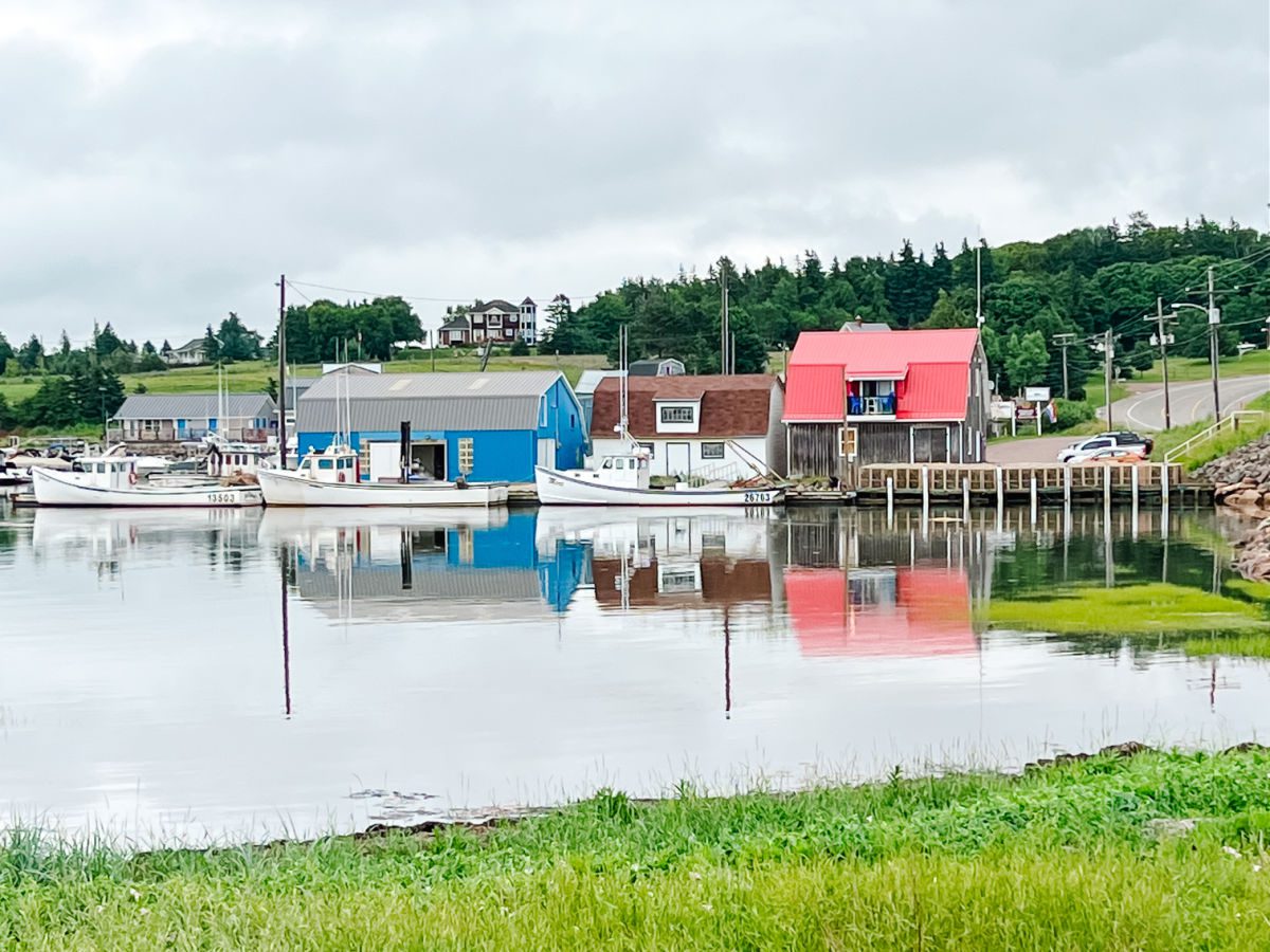 Darnley PE fishing village with reflection of buildings in the water
