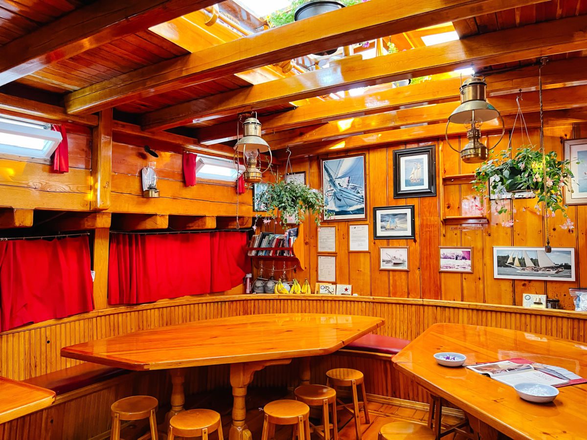 Schooner Heritage galley and eating area with wood paneling and tables