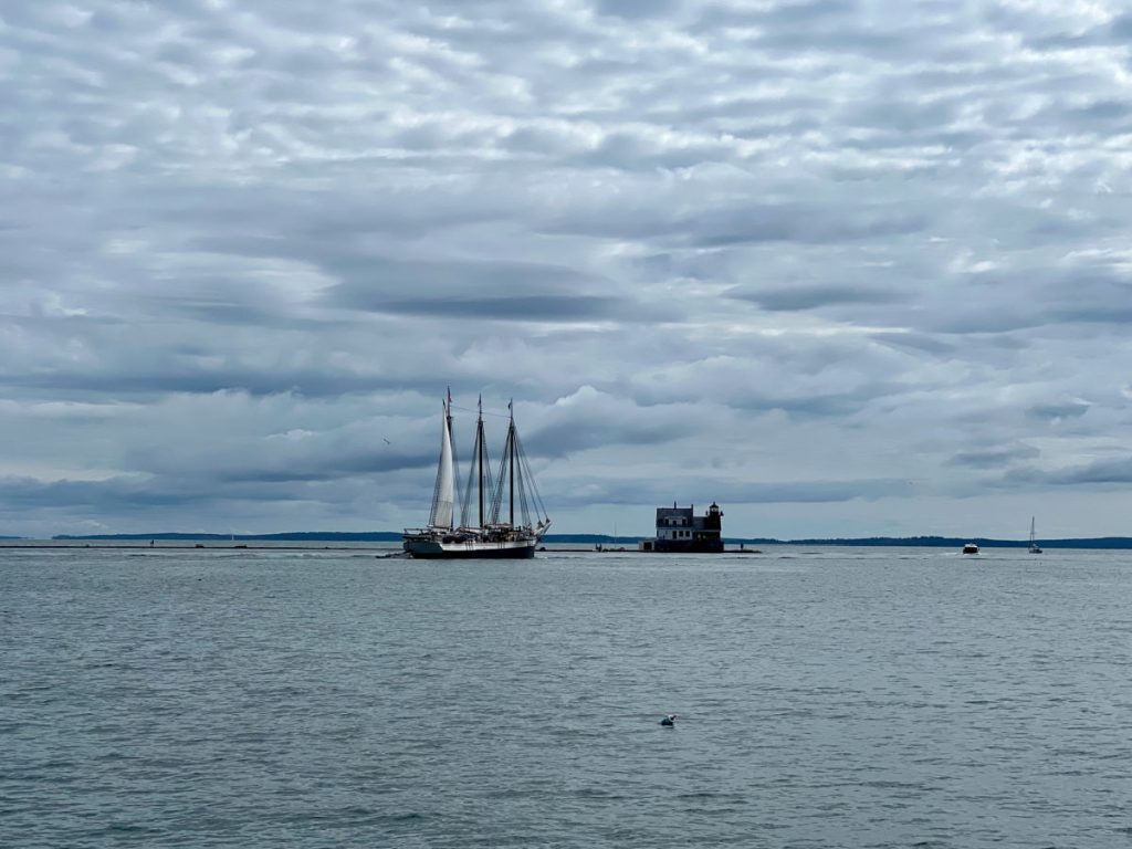 Victory Chimes schooner in front of the Rockland Harbor breakwater light