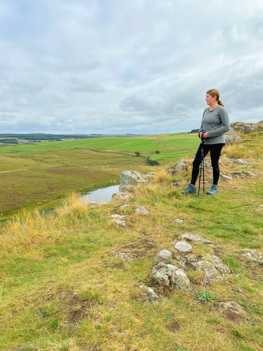 Woman standing on a cliff edge with Crag Lough below