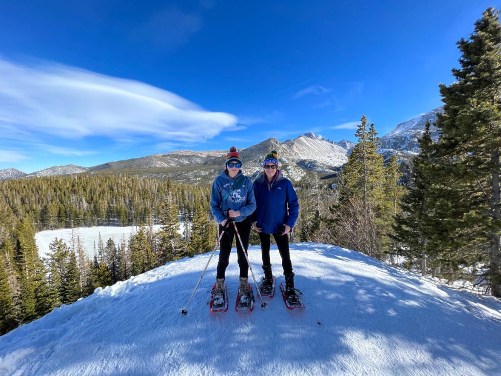 Mother and daughter on mountain in snowshoes in Rocky Mountain National Park