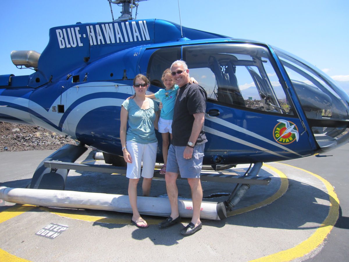 Blue Hawaiian helicopter with a family in front