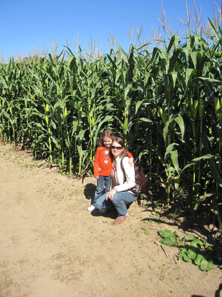 Little girl and mom next to a corn field