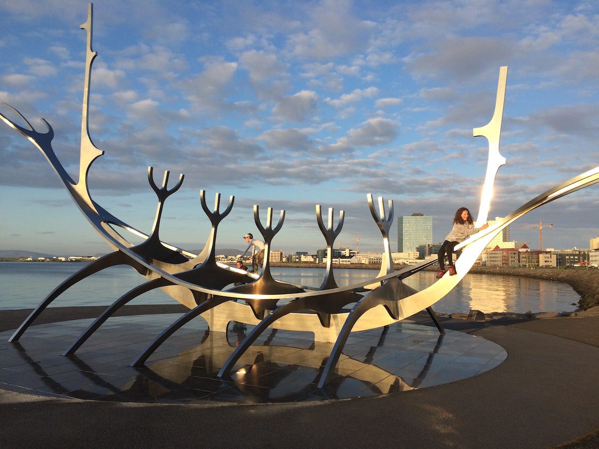 kid climbing on the Sun Voyager sculpture