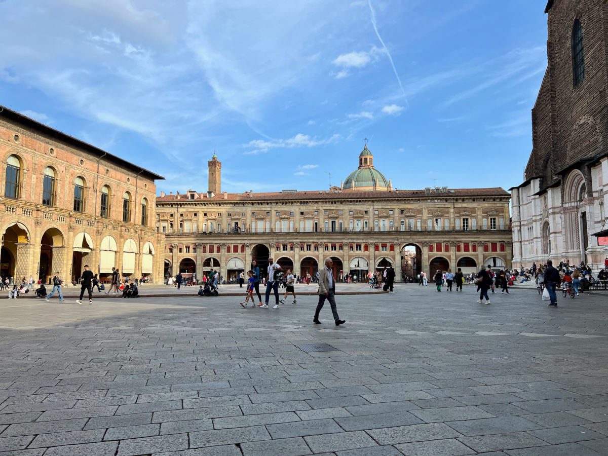 people walking through piazza maggiore in Bologna