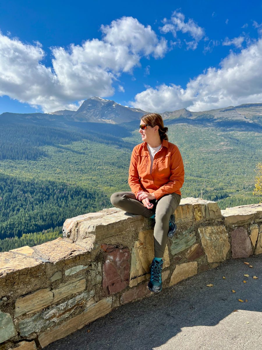 Tamara sitting on wall in Glacier National Park