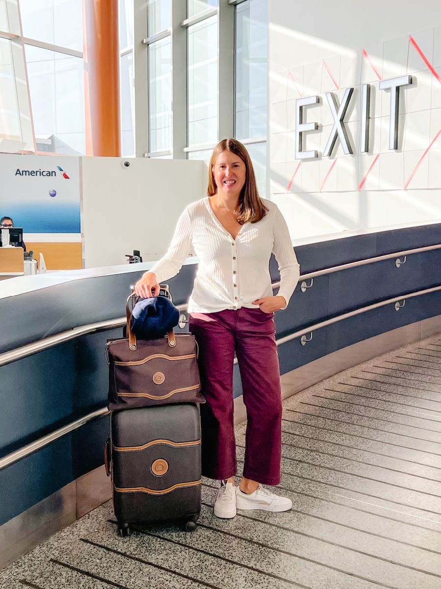 Tamara in airport with suitcase