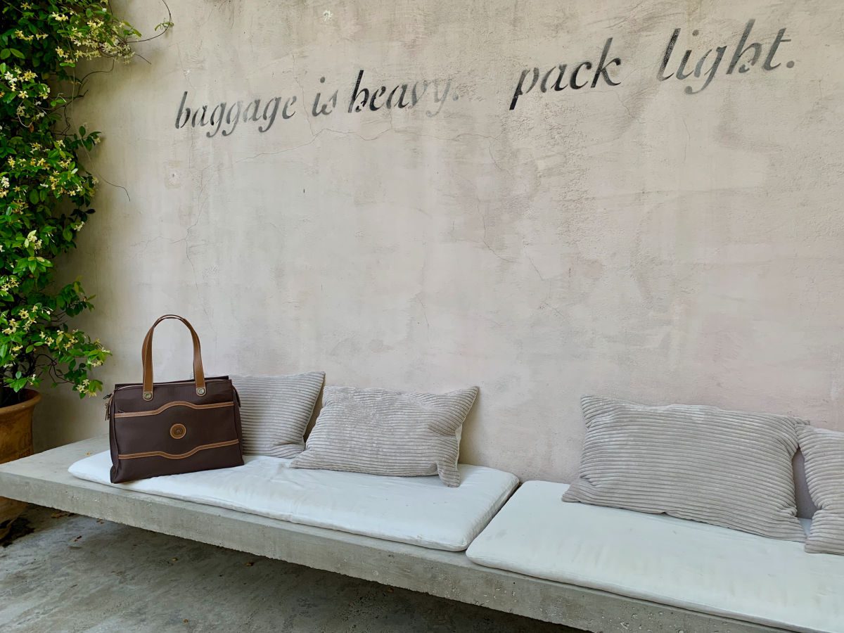 Delsey bag on bench - what to pack for a long flight