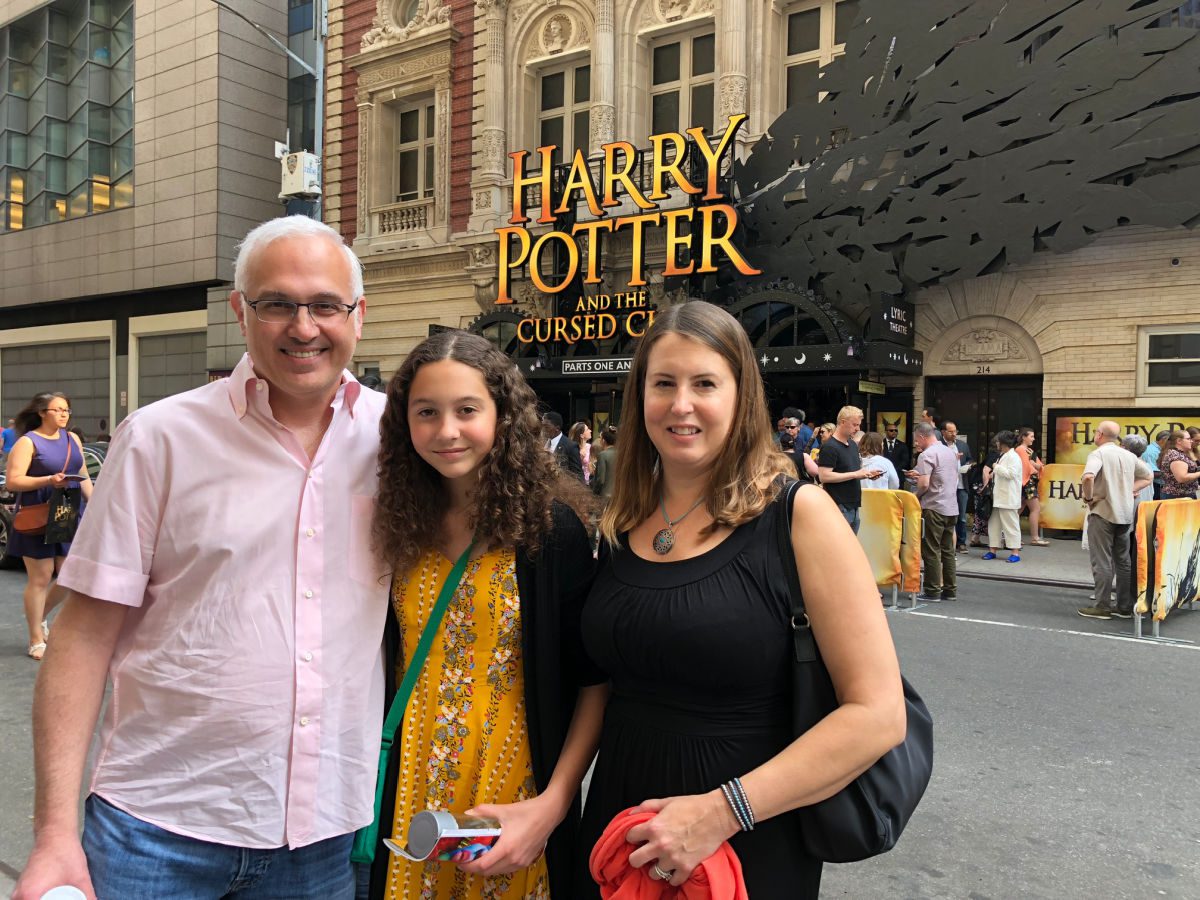 family in front of the Harry Potter and the Cursed Child marquee
