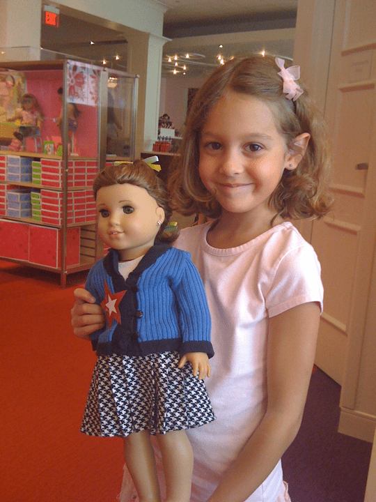 girl holding American girl doll