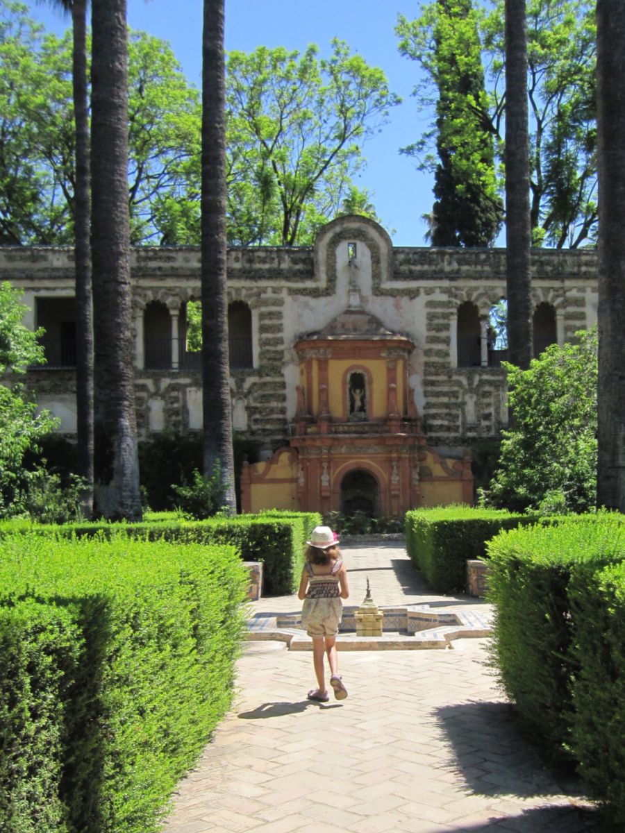 Girl walking through the gardens at the Alcazar in Seville